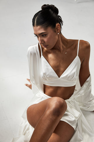 Bride wearing satin bralette and matching satin mini shorts and satin robe