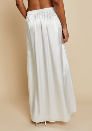 Close up back view of bride wearing white satin maxi skirt 