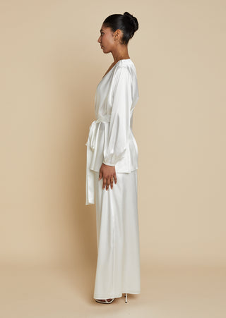 Side view of bride wearing satin robe top with satin maxi skirt