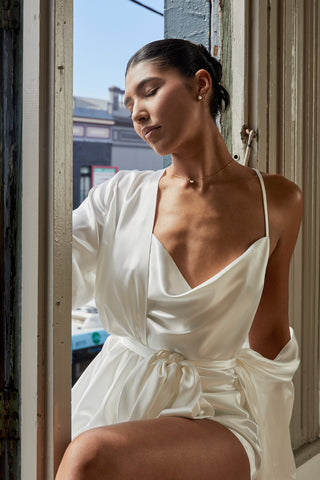Bride wearing satin cowl neck camisole and satin robe