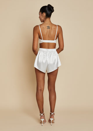 Back view of bride wearing satin bralette and mini short