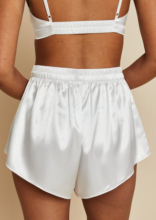 Close up view of bride wearing satin bralette and mini short